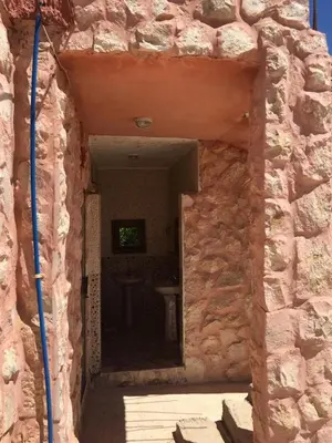 an entrance to a stone building with a doorway at Petra bedouin house in Al Ḩayy