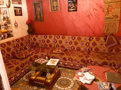 a living room with a couch and a table at Petra bedouin house in Al Ḩayy