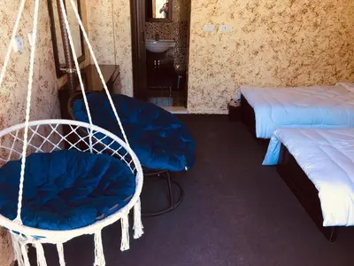 a room with two beds and a swing at Petra bedouin house in Al Ḩayy