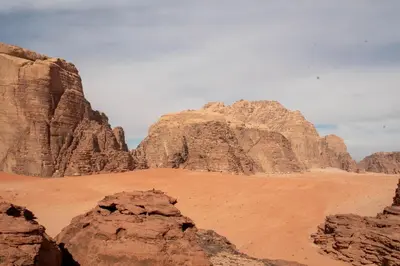 a view of the desert with mountains and rocks at Wadi Rum Nights in Wadi Rum