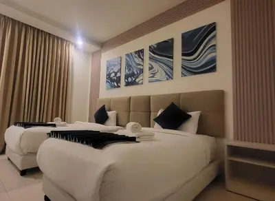 a hotel room with two beds and paintings on the wall at Jordan View Hotel in Amman