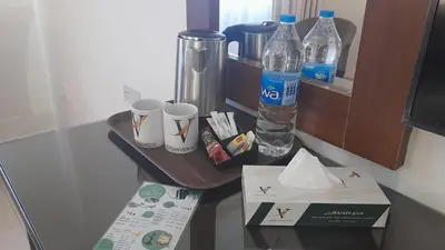 a table with a drink bottle and a box on it at Jordan View Hotel in Amman