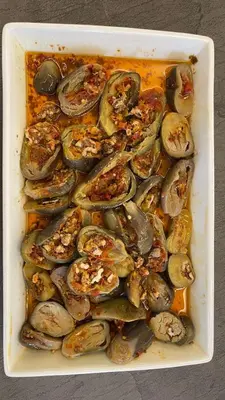 a white dish filled with clams and other food at Jordan View Hotel in Amman