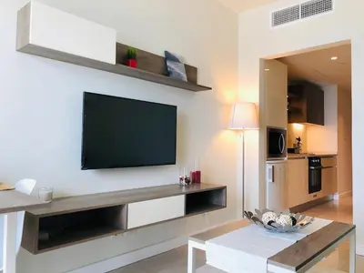 a living room with a flat screen tv on a wall at Porto dead sea in Sowayma