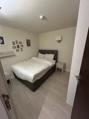 a bedroom with a bed with white sheets and pillows at Porto dead sea in Sowayma