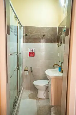 a small bathroom with a toilet and a sink at Jordan Heritage Madhafa in Al Salt