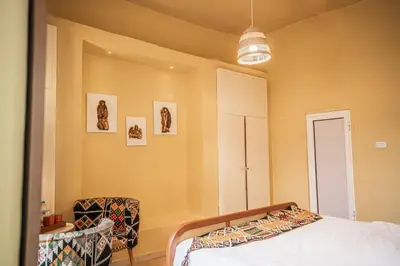 a bedroom with a bed and a chair at Jordan Heritage Madhafa in Al Salt