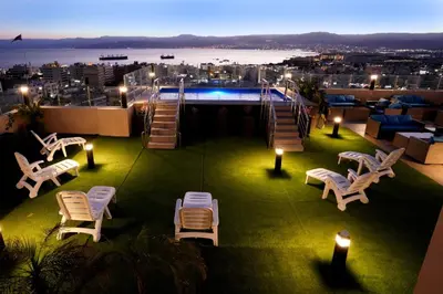 a patio with chairs and a pool on a building at Baity Boutique Hotel in Aqaba