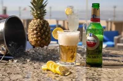 a bottle of beer and lemon slices on a table at Baity Boutique Hotel in Aqaba