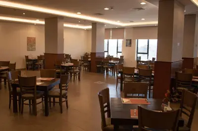 a dining room with tables and chairs in a restaurant at Baity Boutique Hotel in Aqaba