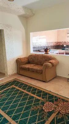 a couch in a living room with a rug at Petra Stones Inn in Wadi Musa