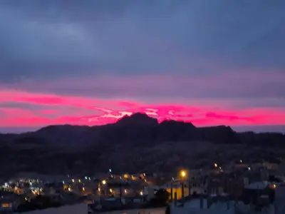 a view of a mountain with a red sunset at Petra Stones Inn in Wadi Musa