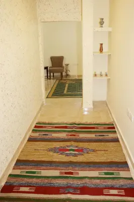 a hallway with a rug on the floor at Petra Stones Inn in Wadi Musa