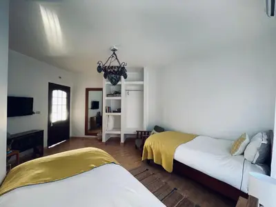 a bedroom with two beds and a chandelier at The Precious Villa in Sowayma