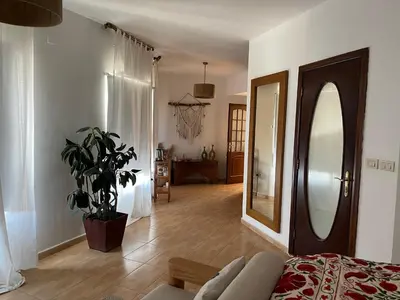 a bedroom with a mirror and a couch in a room at The Precious Villa in Sowayma