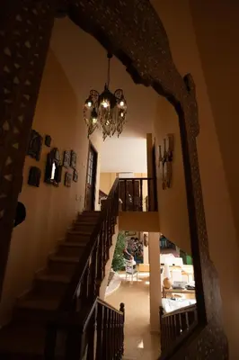 a hallway with a staircase and a chandelier at The Precious Villa in Sowayma