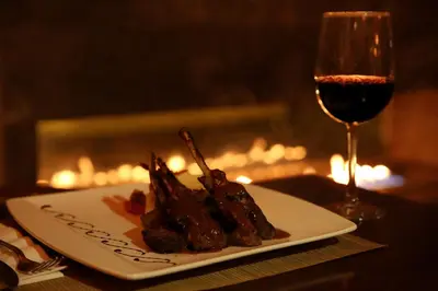 a plate of food and a glass of wine at AlQasr Metropole Hotel in Amman