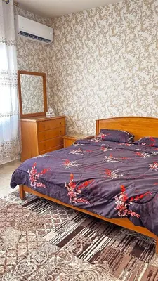 a bedroom with a bed with a purple comforter at Eva house Lovely 3 bedrooms unit in great location in Amman for families in Amman