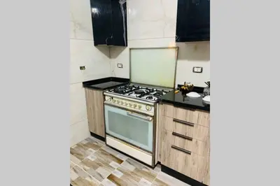 a kitchen with a stove and a counter top at Eva house Lovely 3 bedrooms unit in great location in Amman for families in Amman