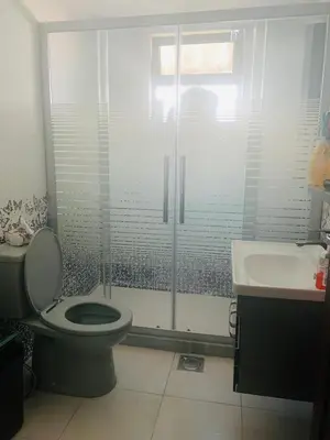 a bathroom with a toilet and a shower and a sink at Eva house Lovely 3 bedrooms unit in great location in Amman for families in Amman