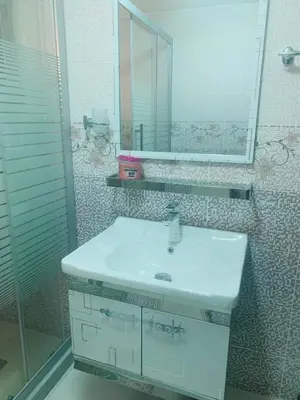 a bathroom with a white sink and a mirror at Eva house Lovely 3 bedrooms unit in great location in Amman for families in Amman