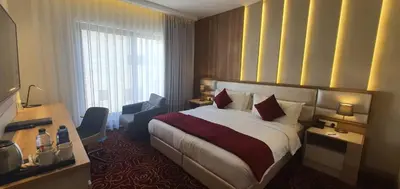 a hotel room with a bed and a window at Lilac Hotel - Amman in Amman
