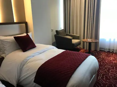 a hotel room with a bed and a chair at Lilac Hotel - Amman in Amman