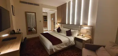 a hotel room with a bed and a couch at Lilac Hotel - Amman in Amman