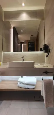 a bathroom with a sink and a mirror at Lilac Hotel - Amman in Amman