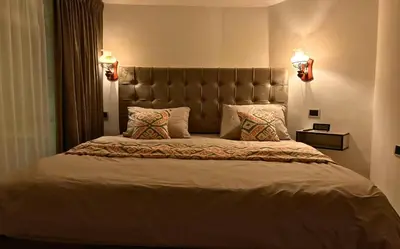 a bedroom with a large bed with two pillows at Celestia Boutique Inn in Jerash