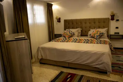 a bedroom with a large bed and a window at Celestia Boutique Inn in Jerash