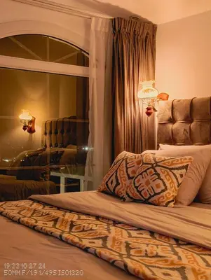 a bedroom with a bed with a large mirror at Celestia Boutique Inn in Jerash