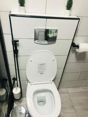 a bathroom with a toilet with a shelf above it at Luxury Apartment in Awesome Location in Amman in Amman