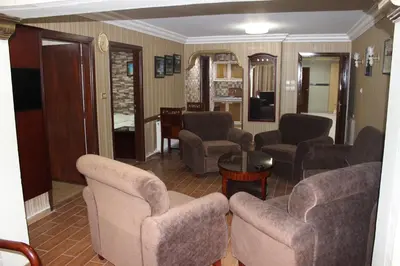 a living room with couches and chairs and a table at Rana Palace in Amman