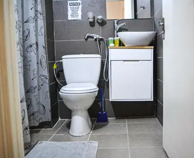 a bathroom with a toilet and a sink at Hikaya studios in Wadi Musa