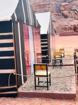 a chair sitting in front of a building in the desert at moon city with jeep trips in Wadi Rum