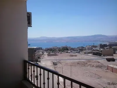 a view of the water from a balcony of a building at Baraka Al Aqaba Hotel Suites in Aqaba