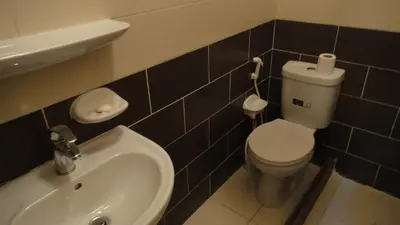 a bathroom with a toilet and a sink at Baraka Al Aqaba Hotel Suites in Aqaba