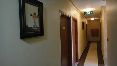 a hallway with a picture of flowers on the wall at Baraka Al Aqaba Hotel Suites in Aqaba
