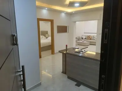 a room with a kitchen and a living room at Executive Apartments in Amman