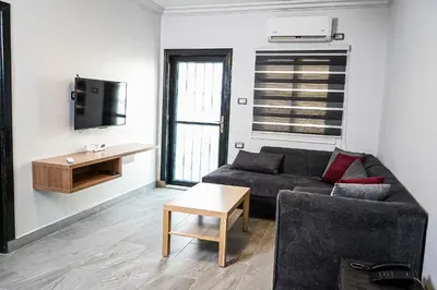 a living room with a couch and a table at flamingo hotel irbid in Zabdah
