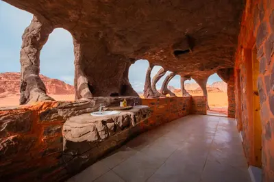 a bathroom in a cave with a sink in the desert at Wadi Rum Cave Camping in Wadi Rum