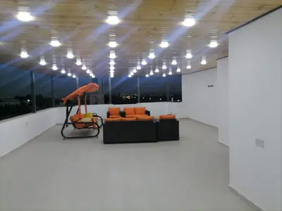 a living room with a couch and an umbrella at For Women Only - للنساء فقط in Umm el ‘Amad