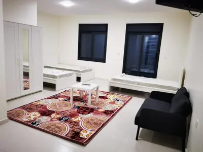 a living room with a couch and a rug at For Women Only - للنساء فقط in Umm el ‘Amad