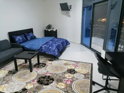 a bedroom with a bed and a couch and a table at For Women Only - للنساء فقط in Umm el ‘Amad