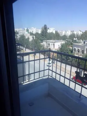 a balcony with a view of a parking lot at Durrat Al Israa in Umm el ‘Amad