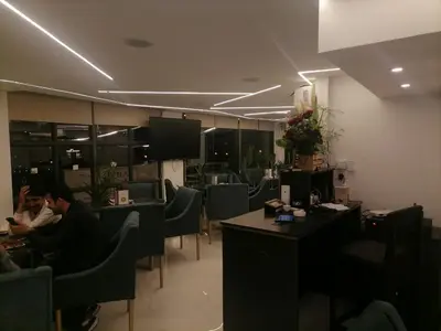 a restaurant with people sitting at tables and chairs at Durrat Al Israa in Umm el ‘Amad