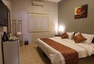 a bedroom with a large bed in a room at Riviera Hotel in Amman
