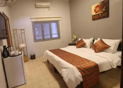 a bedroom with a large bed and a window at Riviera Hotel in Amman