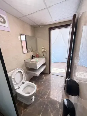 a bathroom with a toilet and a sink and a tub at Sunrise Luxury Camp in Wadi Rum
